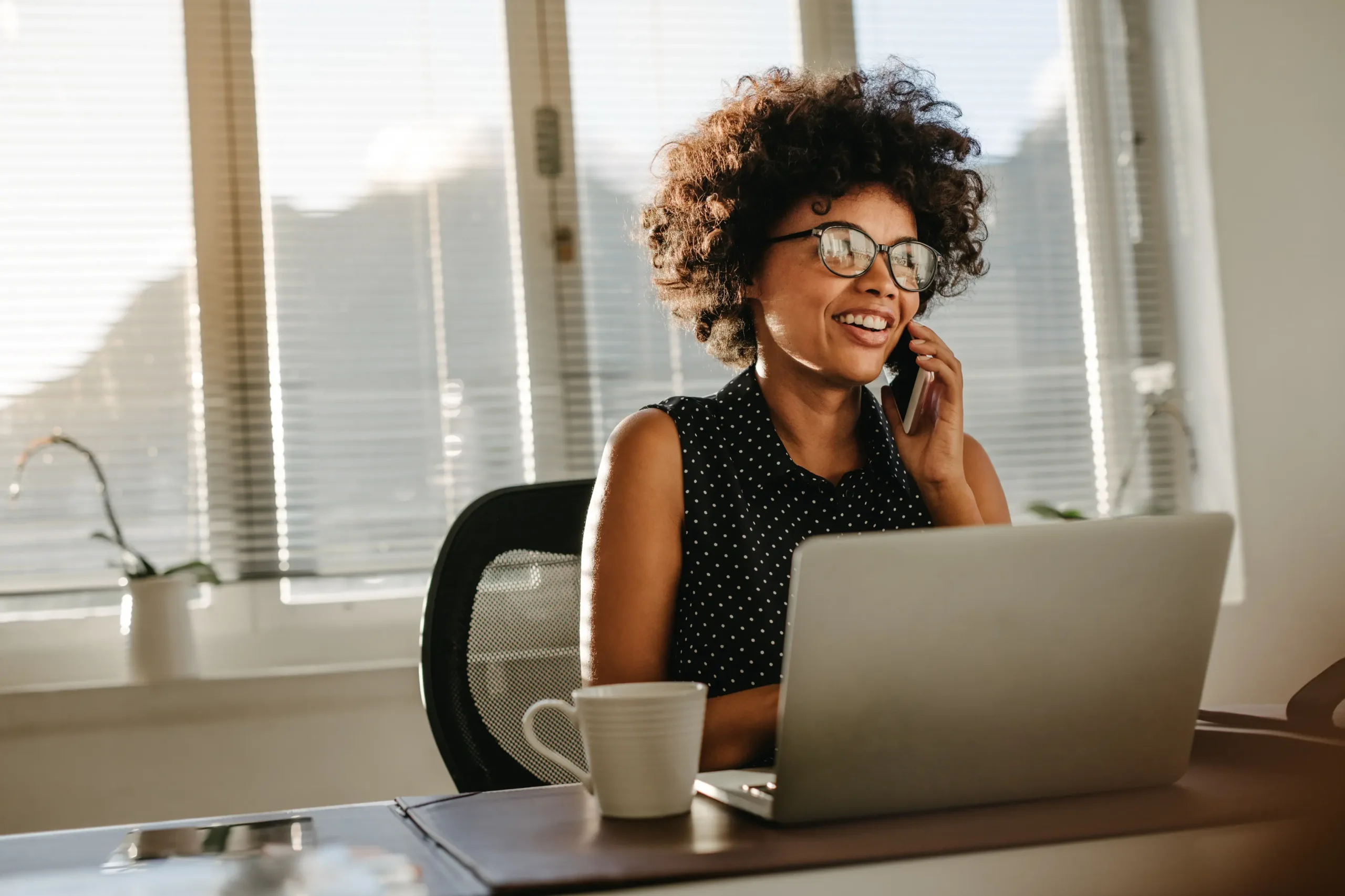 Lady on the Phone with a laptop